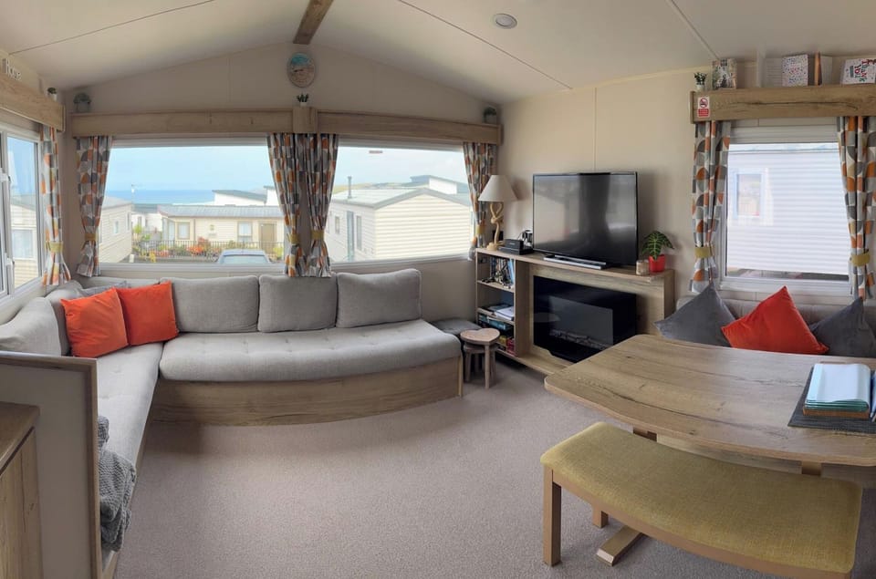 A cosy, light‑filled living space designed for relaxing after a day of adventure — with comfy seating, homely touches, and plenty of room to unwind.