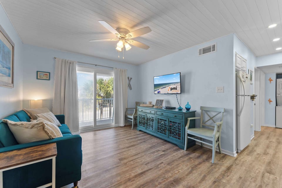 Comfortable living room with coastal touches and plenty of space to unwind after a day at the beach.