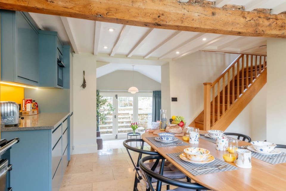 The oak stairs lead up from the kitchen to the first floor