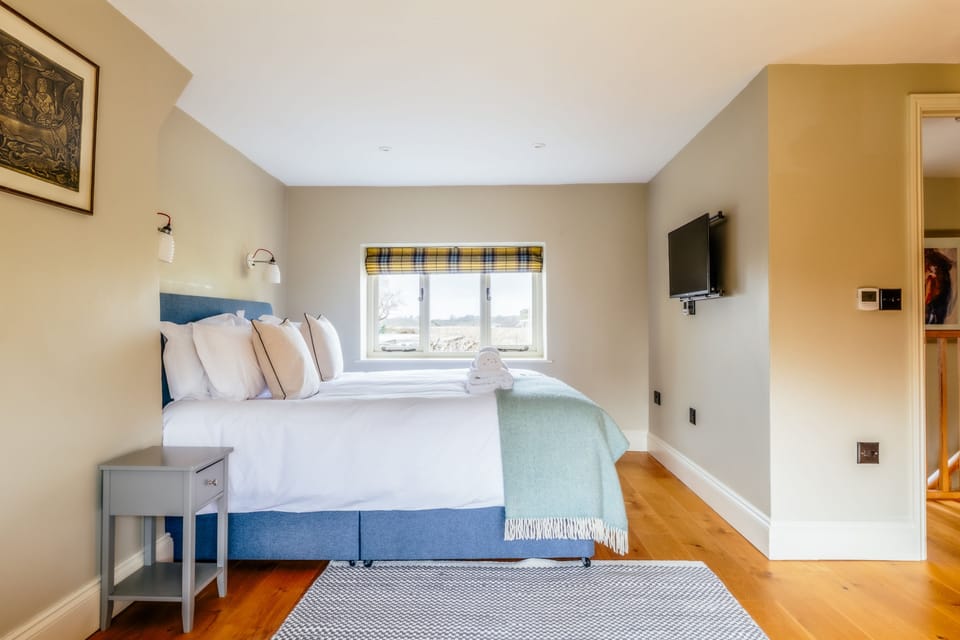 Dual-aspect windows and a television in the bedroom