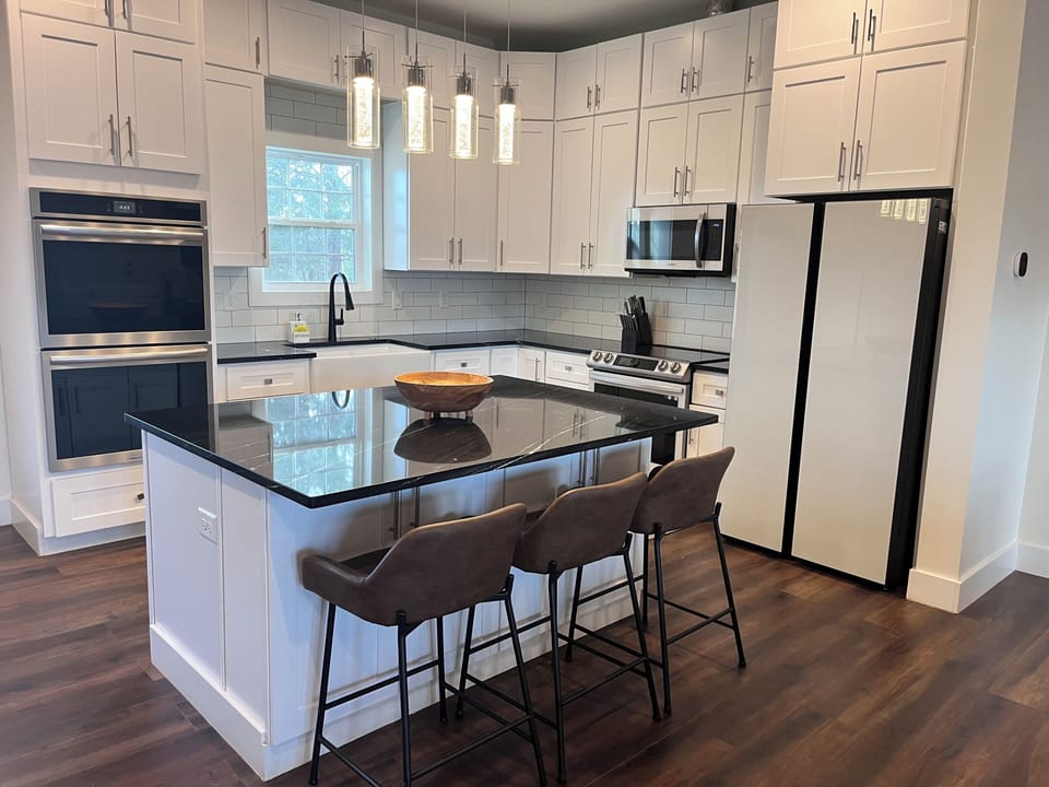 Modern kitchen with stainless appliances a large island with bar seating