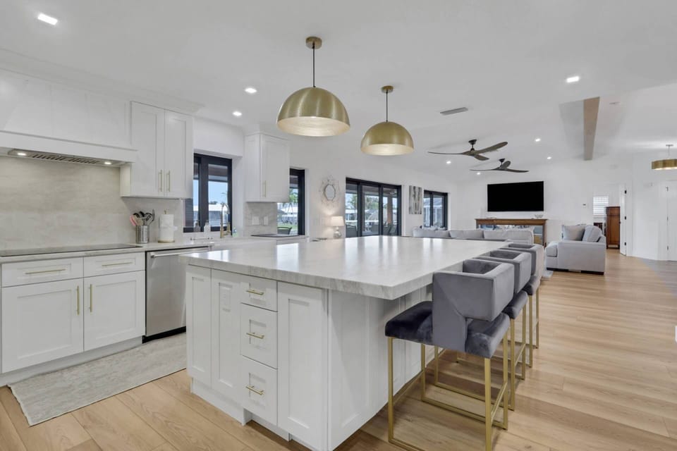 A large eating island with bar stool seating anchors the kitchen space.