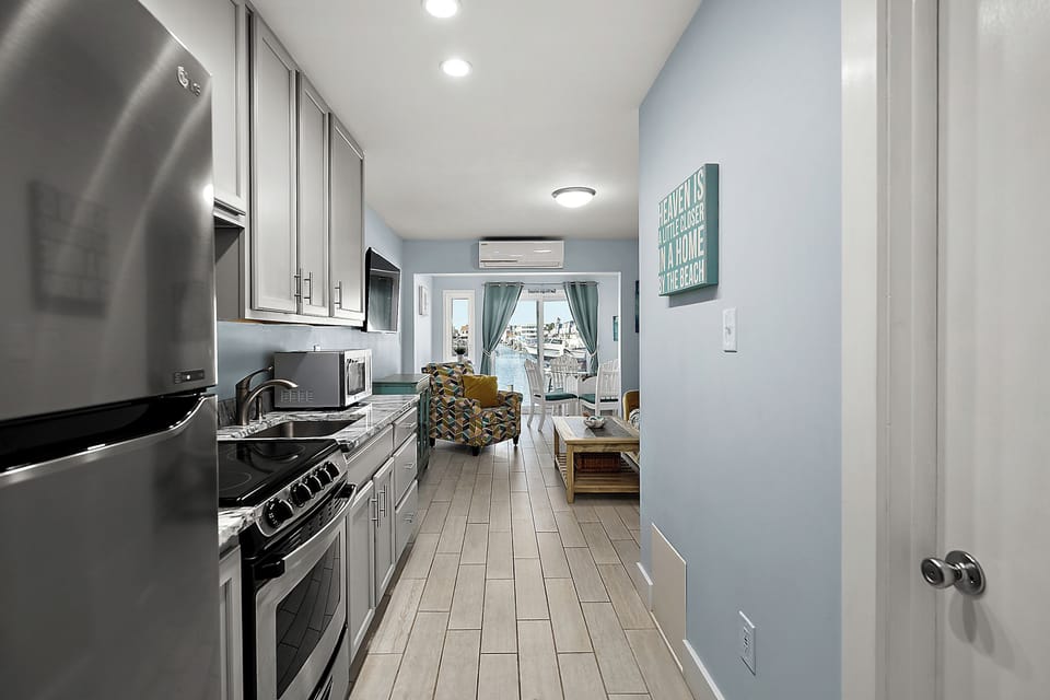 Sleek, narrow kitchen layout that makes it easy to prep meals while still enjoying the waterfront views straight ahead.