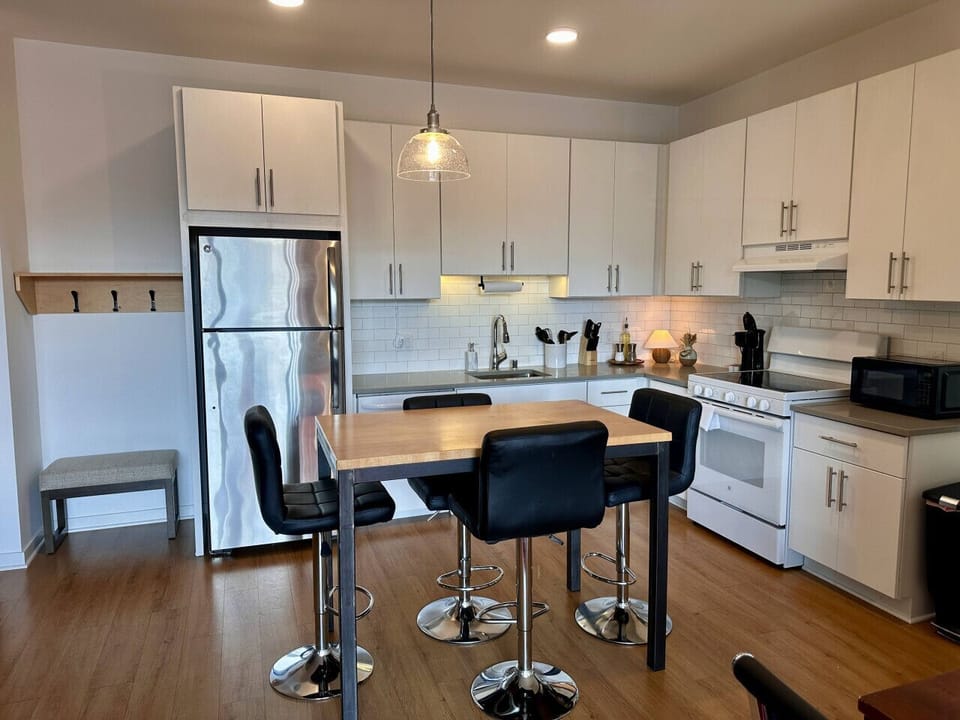 A fully-equipped kitchen with an island and bar stool seating—everything you need to prep, cook, and refuel
