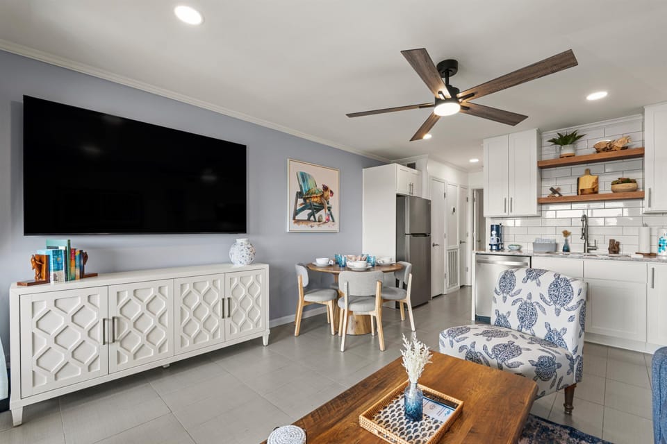 Bright and coastal living/dinning area with 75” smart TV and high speed internet