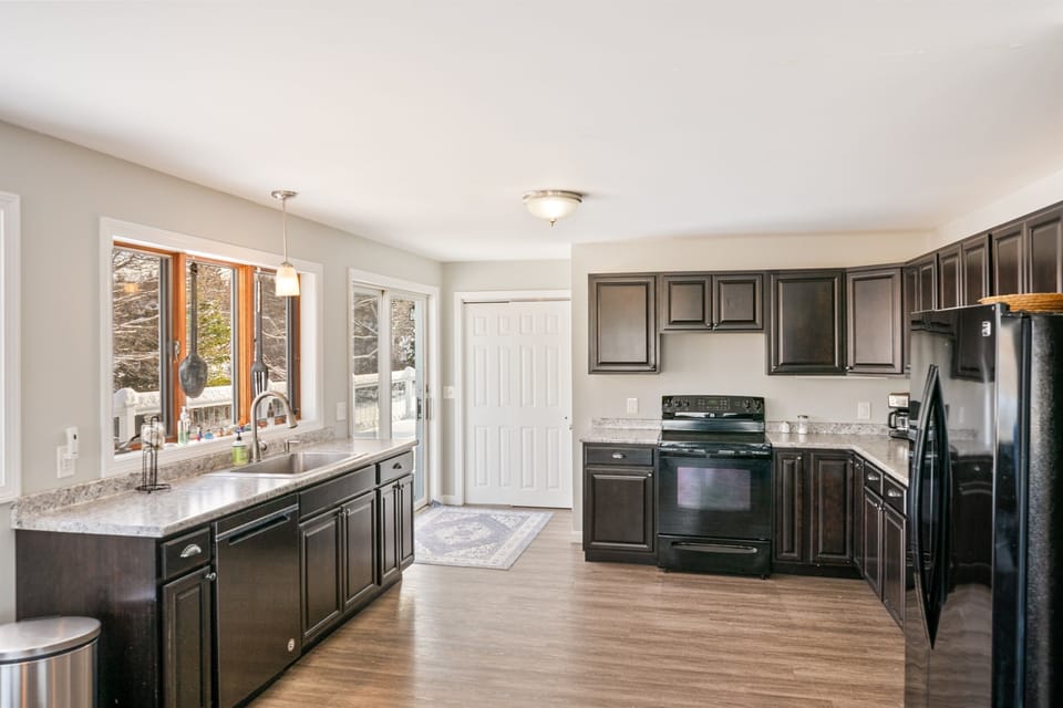 Welcome to Phoenix Aerie. Enter through the sliding door directly into a sun-filled, spacious kitchen. This open layout is perfect for unloading groceries for your Acadia stay and immediately enjoying the harbor views just outside your entrance.