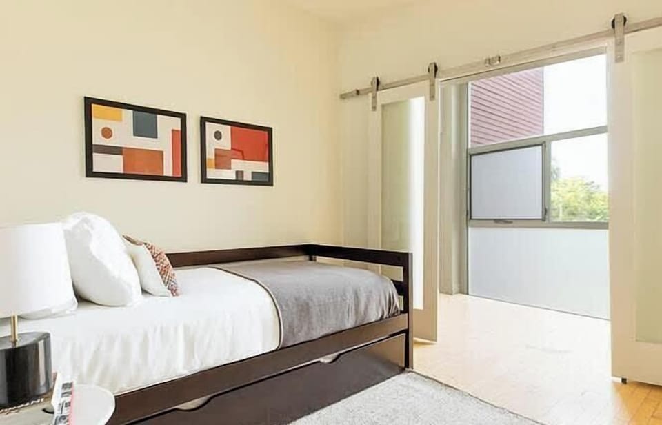 Simple, sunlit bedroom with clean and calming design