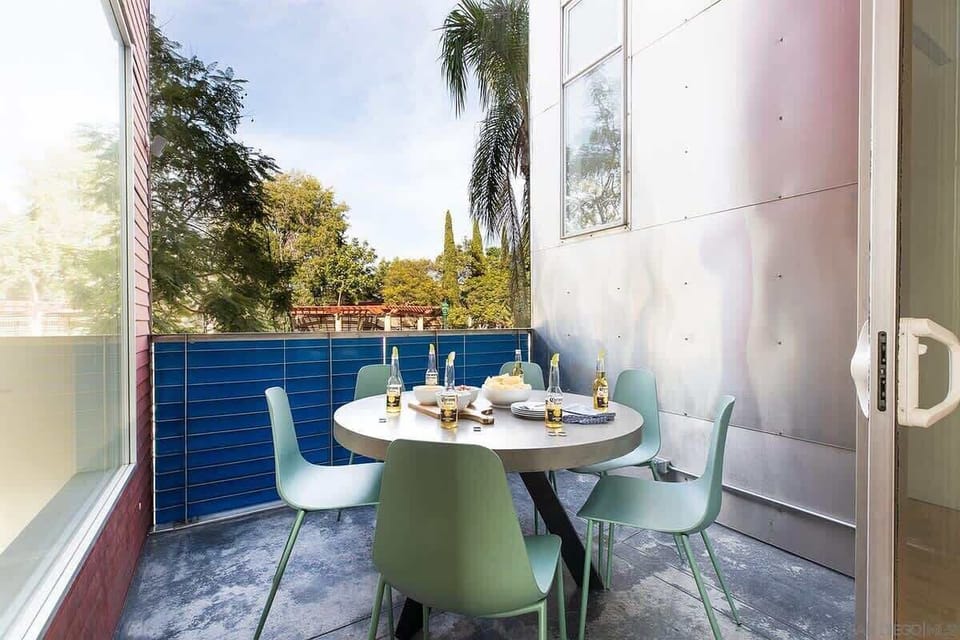 Private balcony with outdoor dining and leafy views