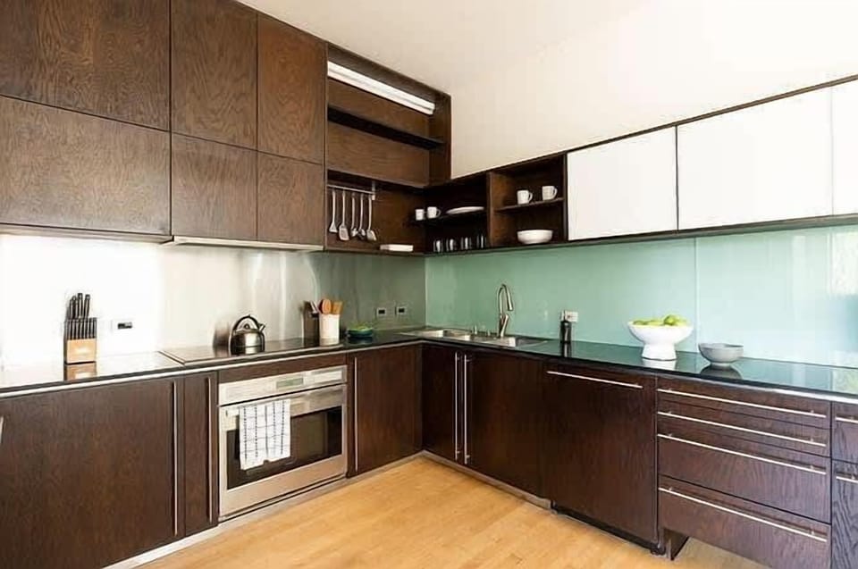 Spacious gourmet kitchen with wood cabinetry and clean lines