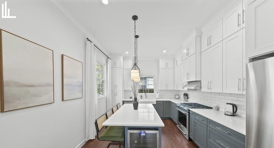 Chef-style kitchen with oversized island seating — perfect for shared meals, entertaining, or extended corporate stays.