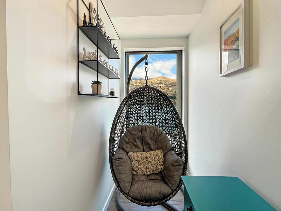 Cozy hanging chair nook with beautiful lake and mountain views