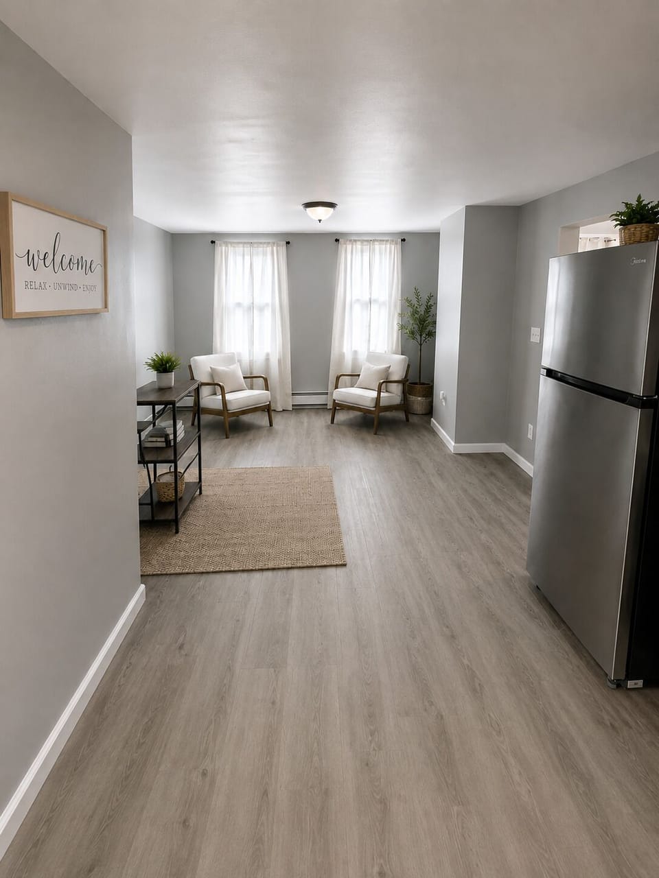 Bright open lounge area with comfortable seating beside the kitchen