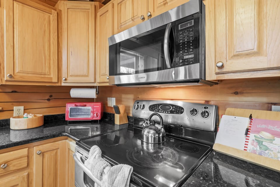 Stove with microwave, toaster oven, and fully stocked cooking area