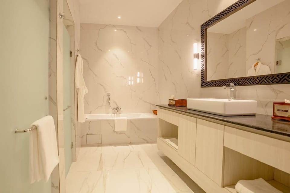Separate tub and shower, hair dryer, slippers, bidet