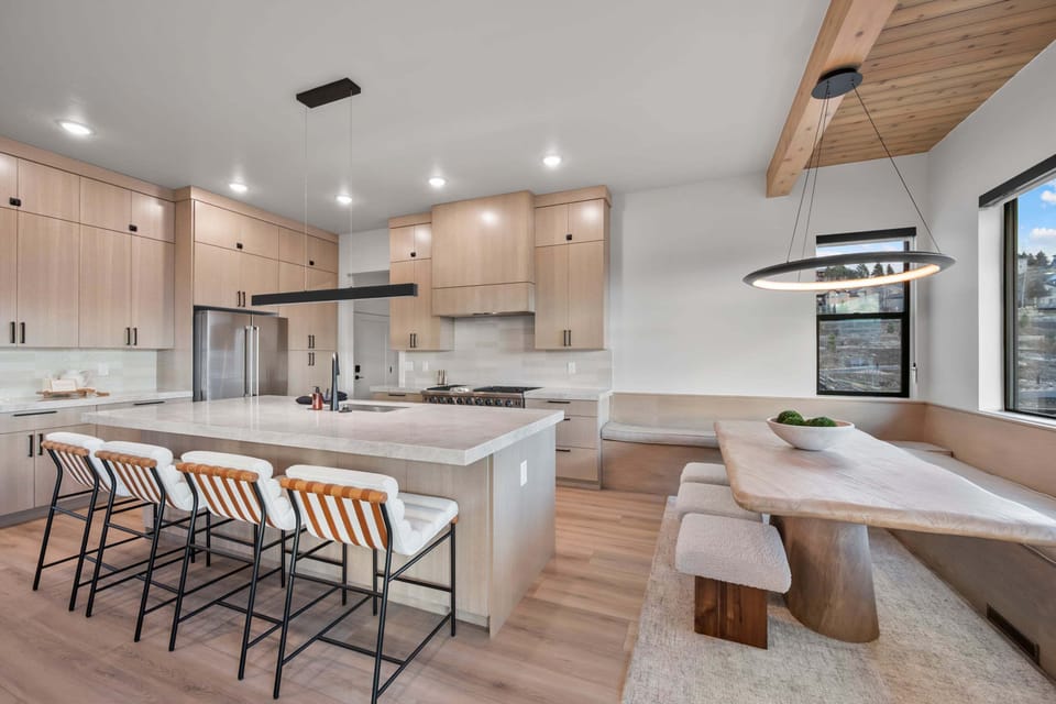 A large well appointed chef's kitchen with massive island, additional seating, butlers pantry, and high end appliances