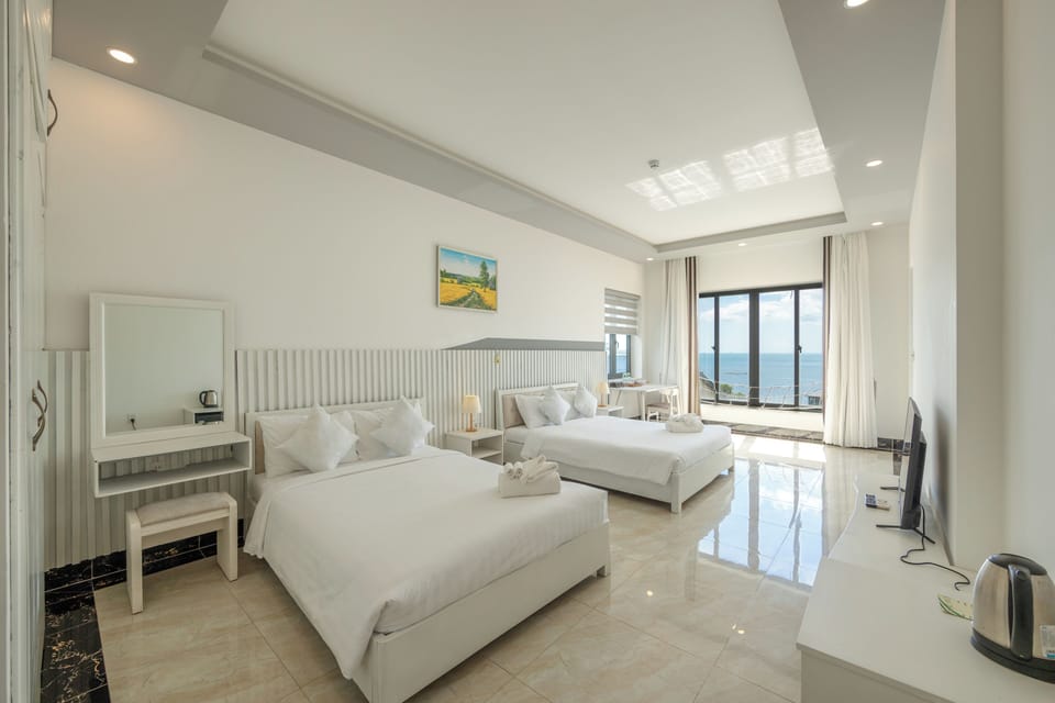 Deluxe Quadruple Room, 2 Double Beds, Sea View | In-room safe, desk, laptop workspace, blackout drapes