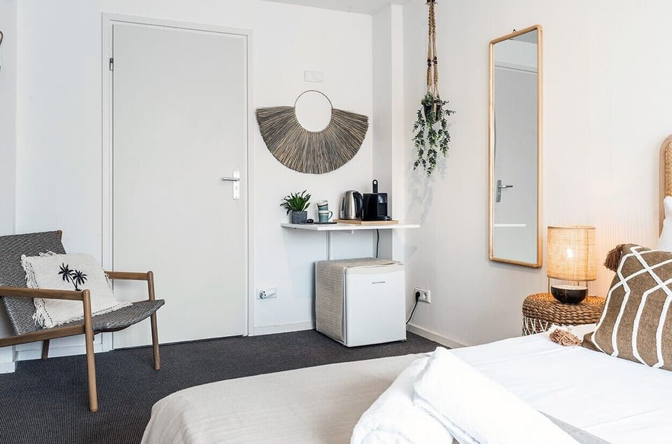Bright bedroom corner with coffee station, mirror, and warm décor—perfect for a relaxed start to the day.