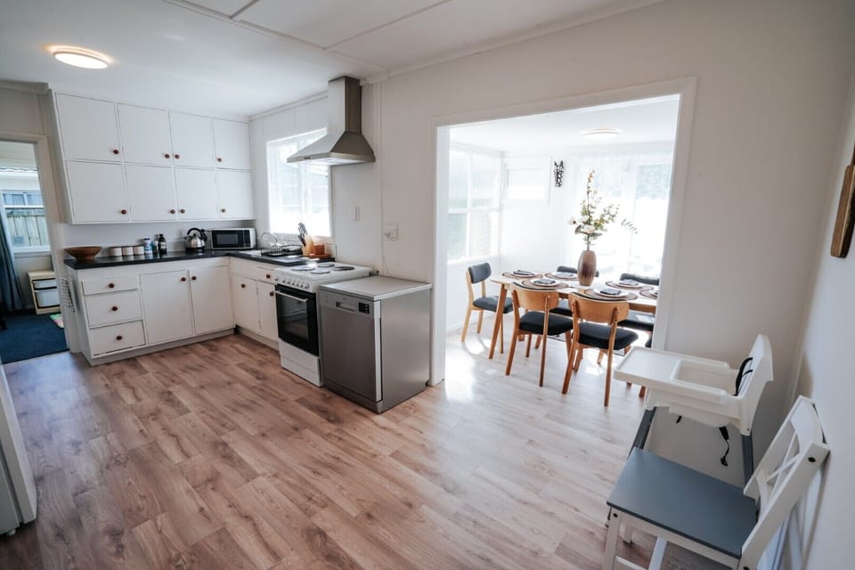 Fully equipped modern kitchen with appliances, ample counter space, and storage. Perfect for cooking meals and entertaining guests.