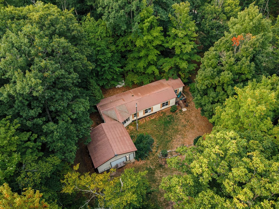 Tucked among the trees, this home offers the perfect escape into nature. Additio