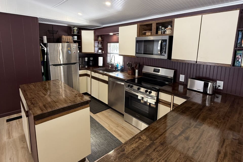 A fully stocked kitchen with modern stainless steel appliances making cooking at