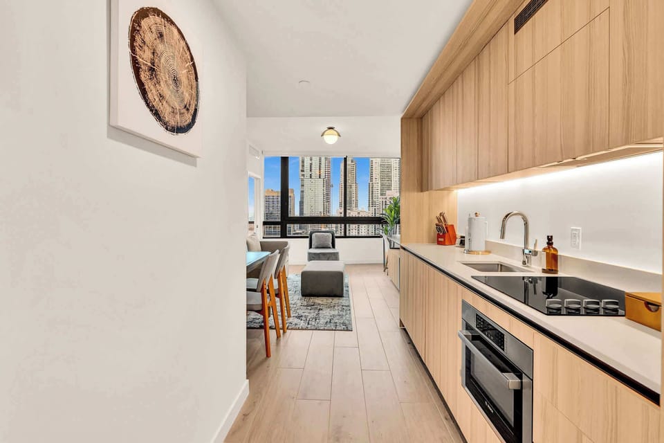Sleek kitchen and dining area with stunning city views, perfect for enjoying meals and relaxing.