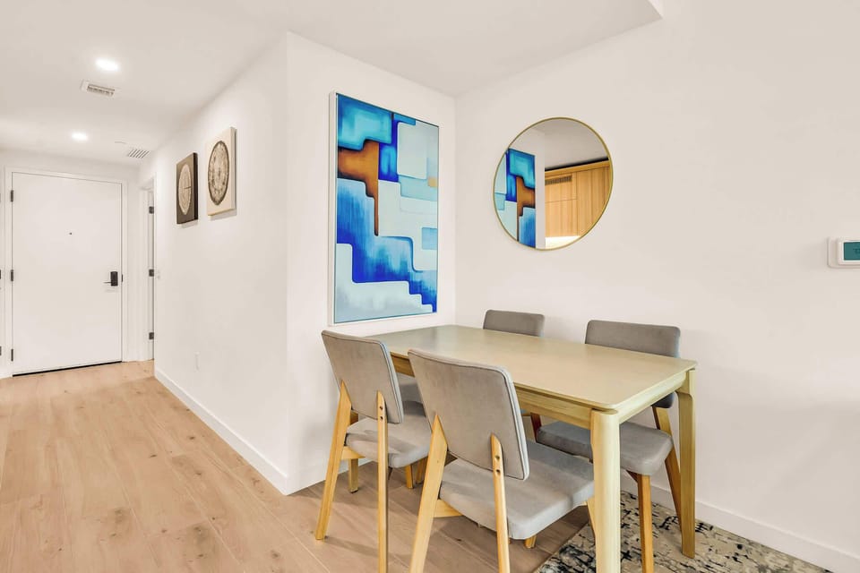 Cozy dining nook with modern art and ample seating for intimate meals.