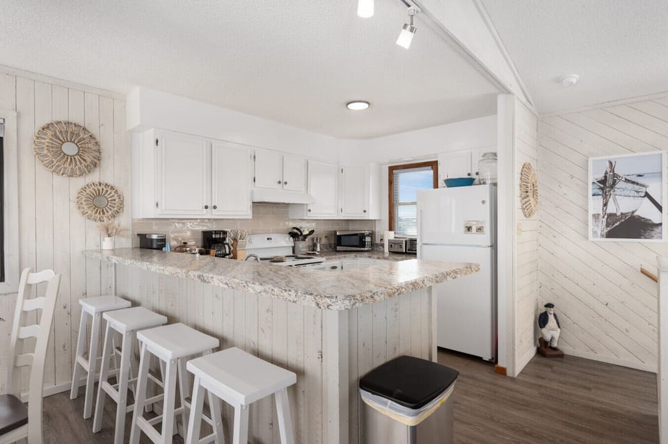 Open kitchen w/ spacious island seating, perfect for casual meals & gathering while cooking