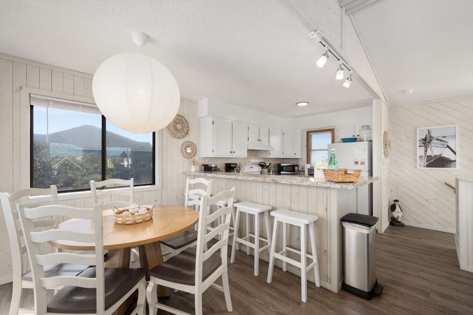 Dining area w/ wood table flows into the kitchen, ideal for shared meals & easy entertaining