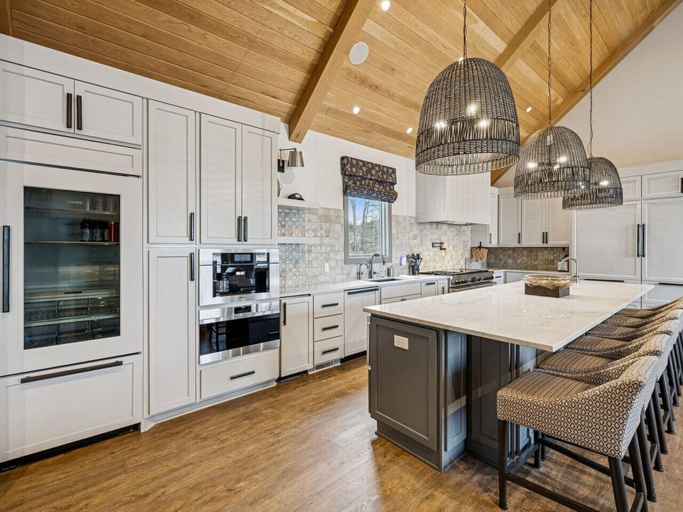 Fully equipped kitchen with large island, coffee maker, drink fridge, gas stove/oven and more