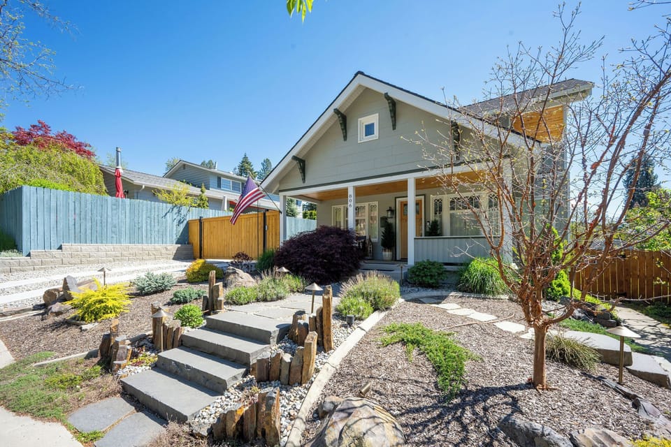 Charming property with a welcoming front porch, manicured landscaping, and residential neighborhood setting. A peaceful arrival experience awaits.