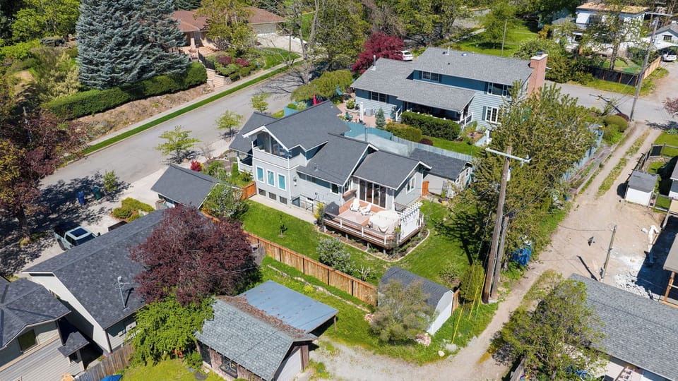 Aerial view showcasing the property nestled in a peaceful residential neighborhood with mature trees, spacious yards, and charming suburban streets defining the surrounding area.