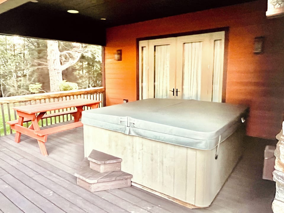 Relax in the hot tub with views of the Pacific Ocean and forest.