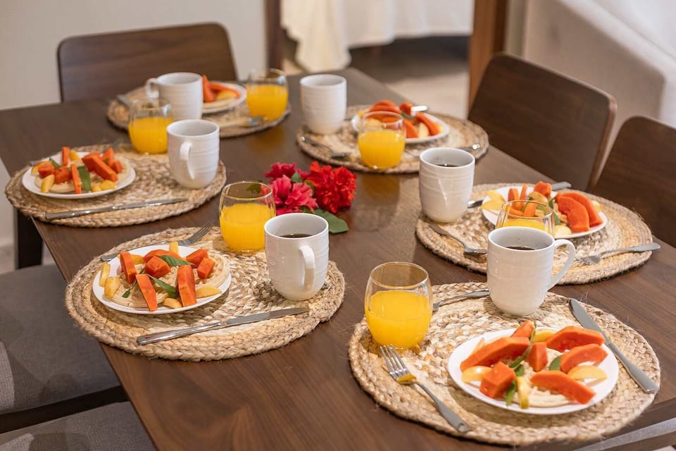 Close-up dining setup w/ fresh plates & drinks ready to enjoy