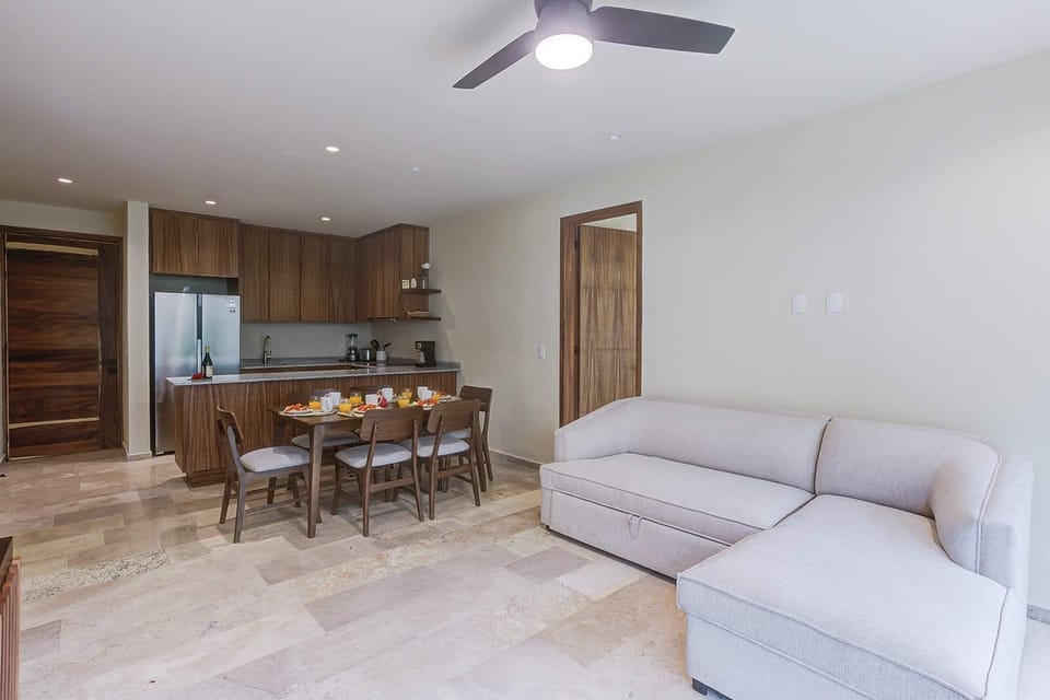 Cozy living area w/ sofa & dining space flowing together