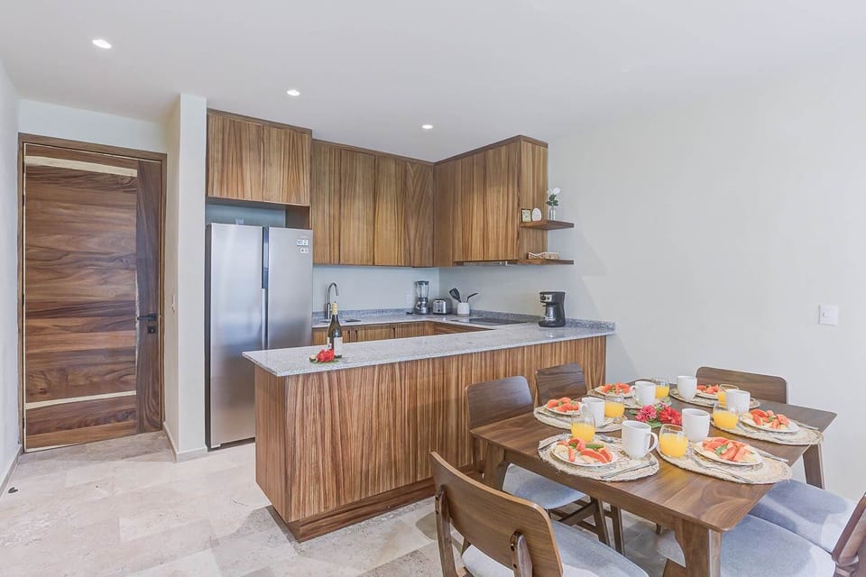 Kitchen & dining combo w/ ample counter space & warm wood finishes