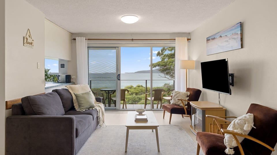 Bright living area with comfy seating and stunning water views