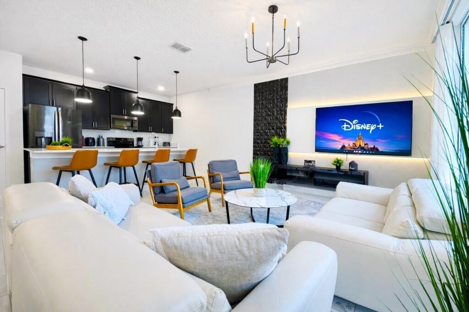Modern living room with sleek kitchen