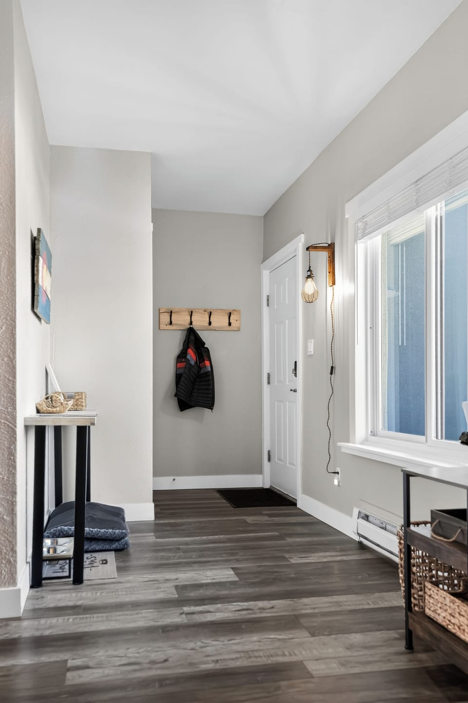 Bright, modern entryway with high ceilings and convenient coat storage