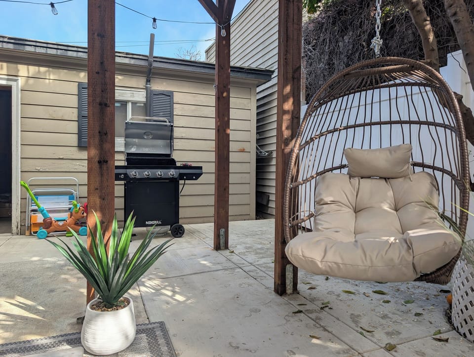 🌿 Your private outdoor retreat awaits. Sip your morning coffee, fire up the grill, or unwind in the cozy hanging chair after a day at the beach.