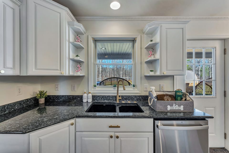 Modern kitchen with granite countertops and gold accents