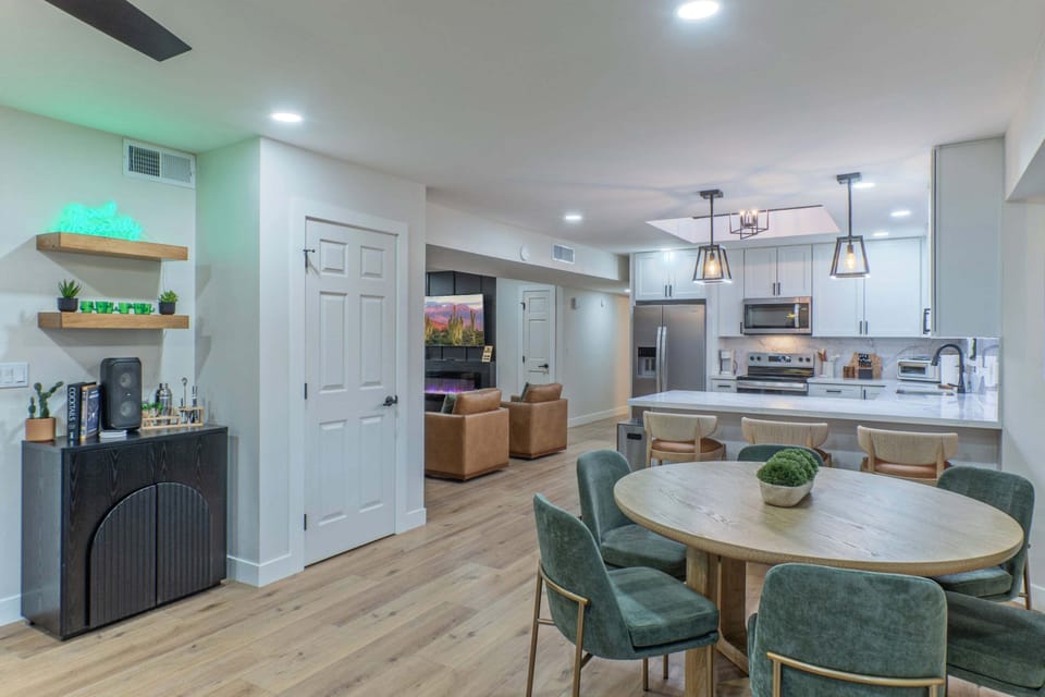 The great room features an open concept with kitchen, dining area, sitting area and coffee bar.