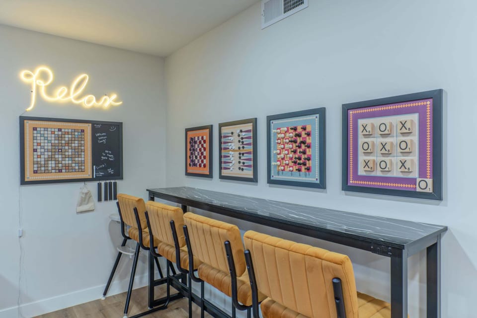 Play games, assemble puzzles or sip favorite beverages at wall length table with cushioned seating.