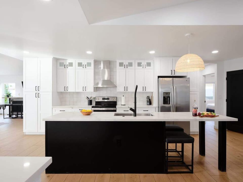 Fully equipped kitchen with stainless steal appliances and a kitchen island with bar seating for 2 guests.