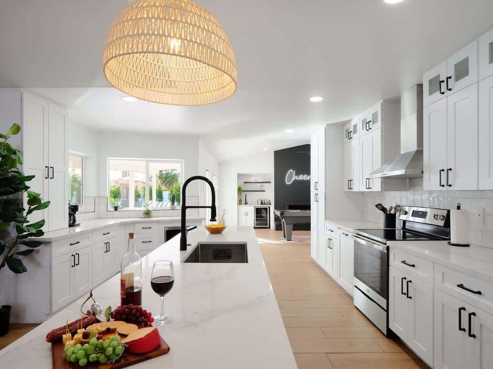 Fully equipped kitchen with stainless steal appliances and a kitchen island with bar seating for 2 guests.