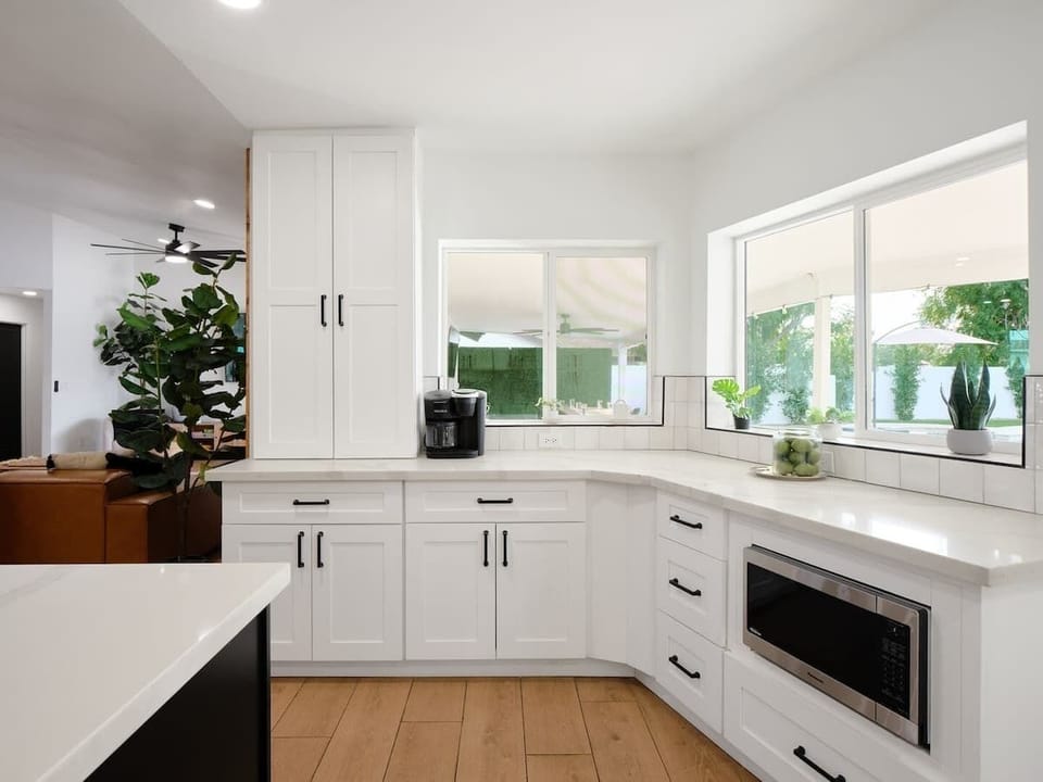 Fully equipped kitchen with stainless steal appliances and a kitchen island with bar seating for 2 guests.