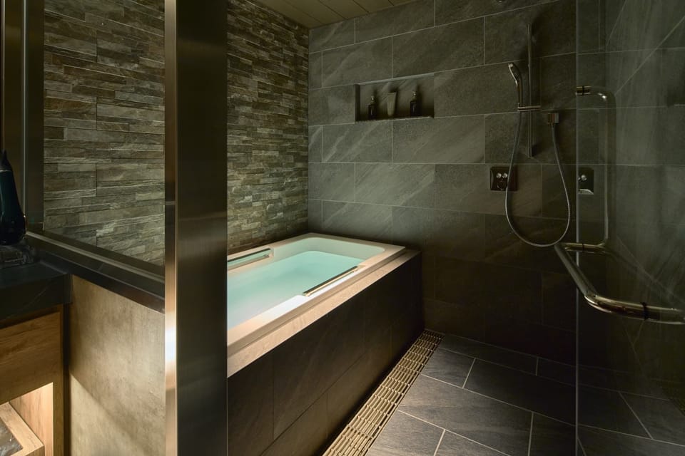 Separate tub and shower, hair dryer, slippers, towels