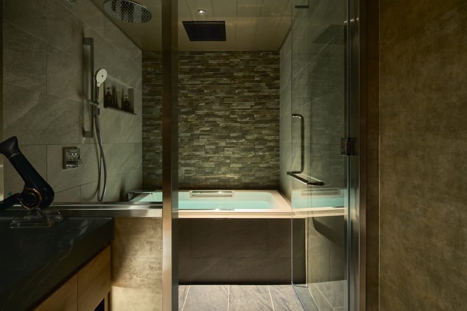 Separate tub and shower, hair dryer, slippers, towels