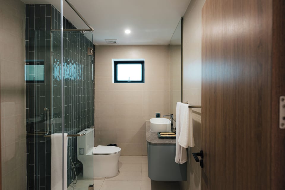 Shower, hair dryer, slippers, towels