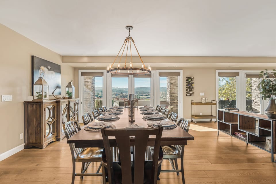 Formal Dining Room - Elegant dining setup with floor-to-ceiling windows and scenic views.