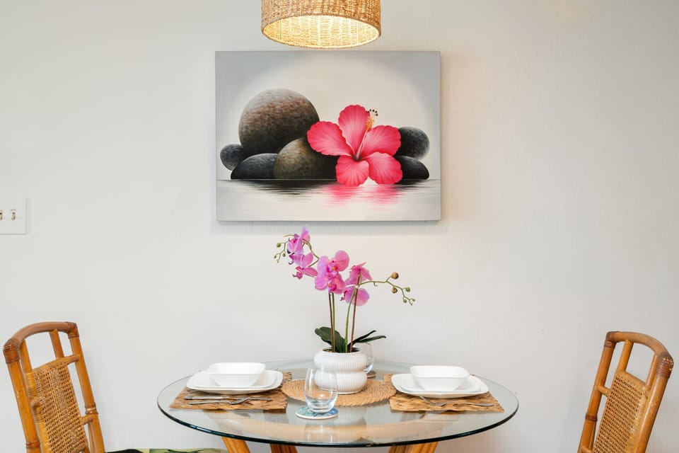 Cozy dining area for two with island-inspired art and décor.